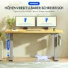 A FlexiSpot height-adjustable desk with dual monitors, a keyboard, and accessories, set in a home office environment. Náhled obrázku produktu