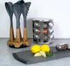 Kitchen utensils and a spice rack are displayed on a countertop with lemons and peppercorns. Anteprima dell’immagine prodotto