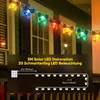 A string of colorful butterfly-shaped LED lights hanging on a house exterior. Produktbild-Vorschau