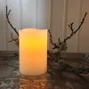 A lit LED candle sits on a decorative tray, with branches and lichen on either side, against a white paneled background. Podgląd zdjęcia produktu