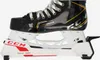 A close-up side view of a black and white CCM hockey skate with yellow accents. Voir les images du produit