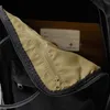 Close-up view of the inside of a black backpack, showing a zippered pocket. Produktbild-Vorschau