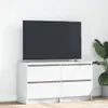 A white TV stand with a large black TV on top, placed against a white wall. Náhľad obrázku produktu