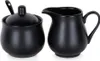 A black porcelain sugar bowl with a lid and spoon, and a black porcelain creamer pitcher are displayed side-by-side on a white background. Produktbild-Vorschau