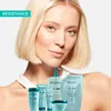 A woman with blonde hair is shown with several Kérastase hair products. Náhled obrázku produktu
