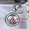 A close-up view of a stainless steel sink drain with a filter and a separate filter basket. Produktbild-Vorschau