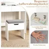 A white vanity stool with a gray upholstered seat is shown in a room with a vanity table. Inset images highlight storage and cushioning. Anteprima dell’immagine prodotto