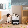 A child and a cat are in a room with a robot vacuum cleaner and its charging station. Náhľad obrázku produktu