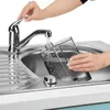 A person is filling a transparent water tank under a faucet in a sink. Produktbild-Vorschau
