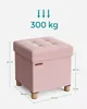 A pink storage ottoman with dimensions and weight capacity indicated by text and arrows. Náhled obrázku produktu