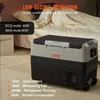 A VEVOR camping refrigerator is shown in a bedroom setting, next to a bed with a person sleeping. Voir les images du produit