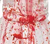 A close-up of a white dress splattered with red paint or blood. Produktbild-Vorschau
