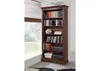 A tall, dark brown wooden bookshelf filled with books and decorative items, placed next to a window with blinds. Produktbild-Vorschau