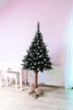 A decorated Christmas tree stands in a room with a desk and radiator. Podgląd zdjęcia produktu