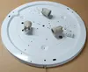 The image shows the underside of a white ceiling light fixture with three E27 bulb sockets and a wire connector block. Anteprima dell’immagine prodotto
