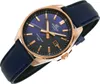 A close-up, angled shot of a men's wristwatch with a blue dial and a rose gold case, set against a white background. Voir les images du produit