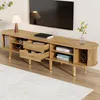 A TV stand with a television mounted above it, in a living room setting. Produktbild-Vorschau