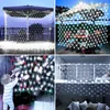 Collage of images showing white net lights used for decoration in various settings, including outdoors under an umbrella, on a Christmas tree, and indoors on a balcony and sofa area. Podgląd zdjęcia produktu