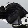 A close-up view of a black and white motorcycle glove. Podgląd zdjęcia produktu