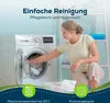 A woman is loading laundry into a washing machine, with shelves of folded towels in the background. The scene is set in a laundry room. Produktbild-Vorschau