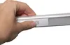 A hand is pressing a button on a silver light fixture. Produktbild-Vorschau