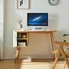 A desk with a computer and decorative items in a room. Produktbild-Vorschau