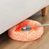 A mop head is being used to clean under a sofa. Náhled obrázku produktu