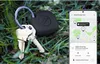 A black Samsung Galaxy SmartTag and keys are placed on grass, with a smartphone displaying the SmartThings Find app in the background. Anteprima dell’immagine prodotto