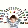 A young boy is lying on his back with his hands behind his head, smiling, surrounded by a collection of toy cars arranged in a semi-circle above him. Náhľad obrázku produktu