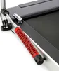 Close-up of a red and black handle attached to a treadmill. Voir les images du produit