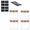 A set of four glass storage jars with bamboo lids and a sheet of chalkboard stickers. Produktbild-Vorschau