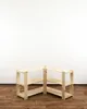 An empty wooden corner shelf unit against a white wall and wooden floor. Produktbild-Vorschau