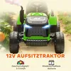 A green toy tractor with a trailer, shown from the front in an outdoor setting with pumpkins and grass. Náhľad obrázku produktu
