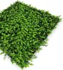 A close-up, angled view of a modular wall panel covered in dense, artificial green foliage. Produktbild-Vorschau