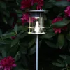 A solar-powered garden light illuminates a cluster of pink rhododendron flowers at dusk. Produktbild-Vorschau