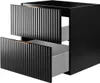 A black bathroom cabinet with two drawers, one partially open, showing the interior. The cabinet has fluted drawer fronts and gold handles. Anteprima dell’immagine prodotto