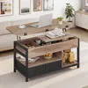 A lift-top coffee table in a living room setting, with a laptop and coffee cup on top. Voir les images du produit