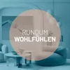 A modern living room scene with a large beanbag chair and coffee tables, featuring a circular overlay with text. Náhľad obrázku produktu