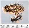 A pile of warm white LED cluster lights on a light gray and white background. Voir les images du produit