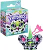 A Furby Furblet toy in its packaging, with the toy also shown outside of the box. Produktbild-Vorschau
