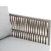 Close-up of the woven armrest and cushion of an outdoor lounge set. Podgląd zdjęcia produktu