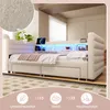 A beige upholstered daybed with LED lighting and storage drawers, shown in a bedroom setting with decorative elements. Produktbild-Vorschau