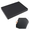 A black foam insert with a grid pattern, shown from an angle. A small inset shows a hand bending a piece of the foam. Produktbild-Vorschau
