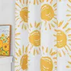 A close-up view of a white curtain with a repeating pattern of yellow suns. Produktbild-Vorschau