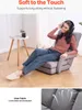 A woman is sitting on a floor chair and listening to music. Produktbild-Vorschau
