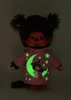 A plush toy Monchhichi doll wearing a pink pajama top with glow-in-the-dark moon and star motifs. Produktbild-Vorschau