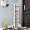 A white multi-tiered shoe rack filled with slippers is placed next to a dark door in a room with light blue walls. Produktbild-Vorschau