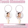 Two compact mirrors are shown, each with a woman applying makeup reflected in it. A finger is shown touching the mirror in each image, indicating a touch feature. A slider bar at the bottom suggests brightness adjustment. Produktbild-Vorschau