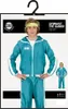 A person wearing a teal tracksuit with white stripes, presented on a hanger with packaging. Produktbild-Vorschau
