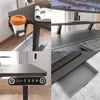 A collage of four images showing different aspects of a black standing desk, including a cup holder, a monitor stand, a keyboard, and a control panel. Náhľad obrázku produktu